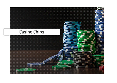 A stack of chips is photographed arranged neatly on the casino table.