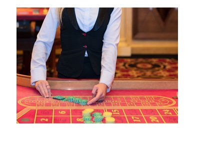 Live female dealer shown in front of a red roulette table.